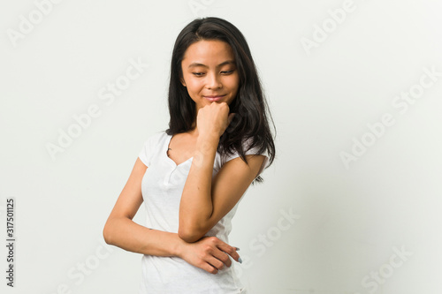 Young chinese woman posing on a white background