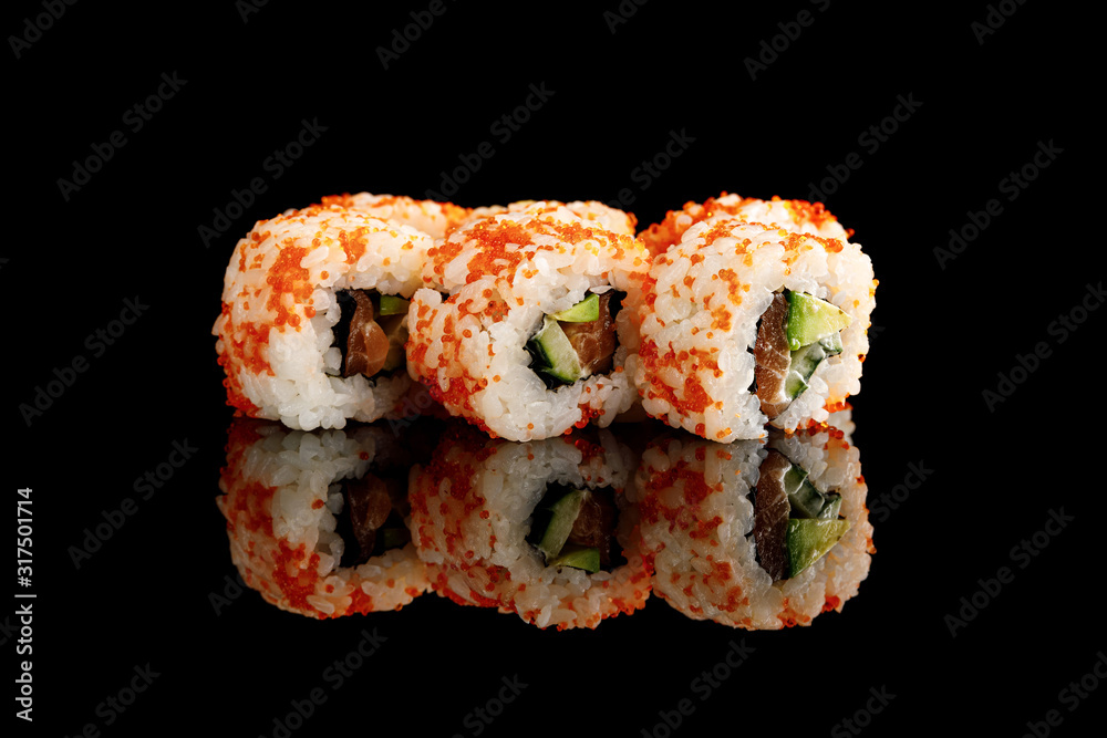 delicious California roll with avocado, salmon and masago caviar isolated on black delicious California roll with avocado, salmon and masago caviar isolated on black