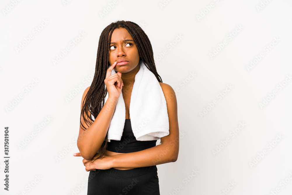 Young african american sport woman isolated looking sideways with doubtful and skeptical expression. Young african american sport woman isolated looking sideways with doubtful and skeptical expression.