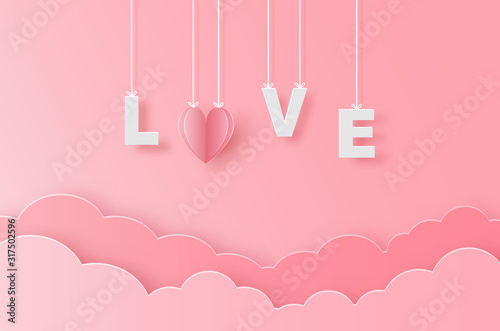 Paper pink heart and text love holding by sling on pink sky