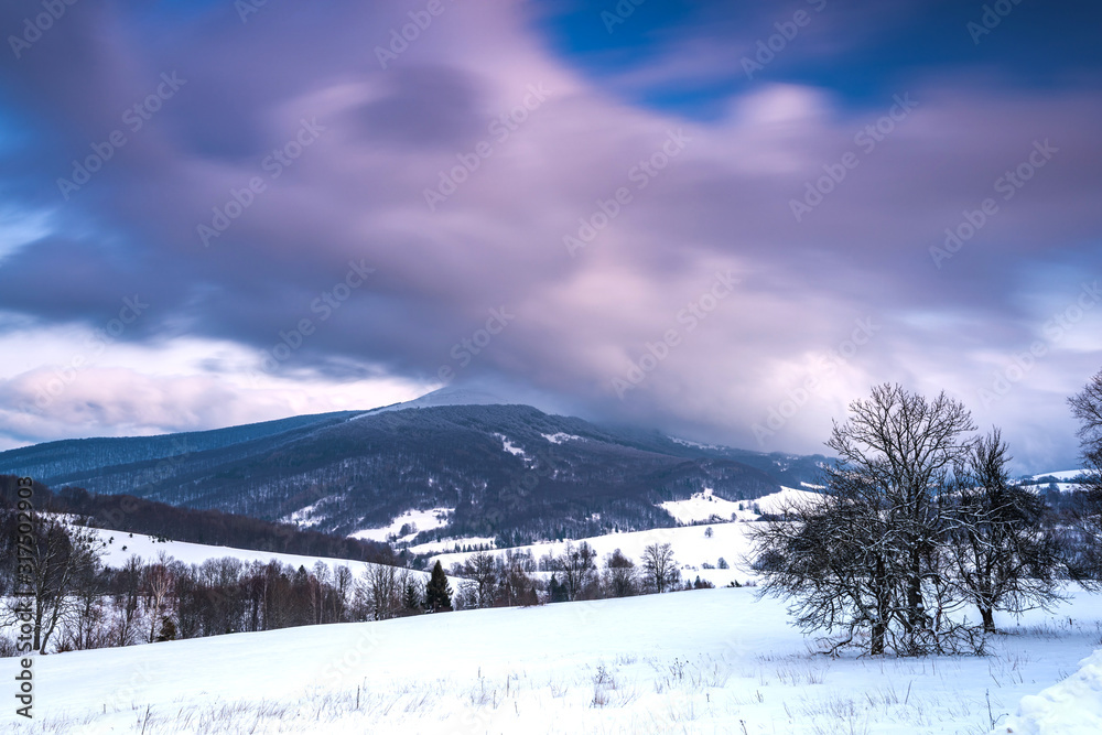 Fototapeta premium Sunrise in Bieszczady Mountains in Winter. Long Exposure. Snowy Hills and Meadows