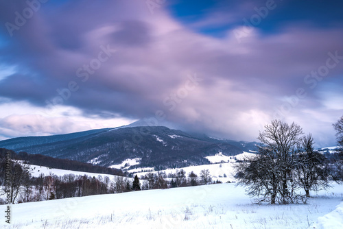 Sunrise in Bieszczady Mountains in Winter. Long Exposure. Snowy Hills and Meadows