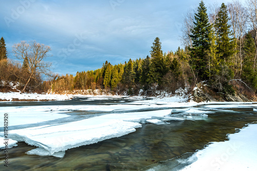 Fototapeta Naklejka Na Ścianę i Meble -  Ice over River San in Bieszczady Mountains at Winter Season