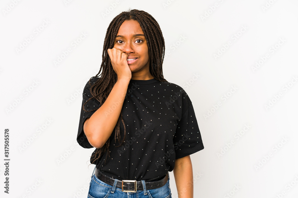 Young african american woman isolated on white background biting fingernails, nervous and very anxious. Young african american woman isolated on white background biting fingernails, nervous and very anxious.