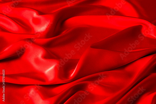 Red ruby color silk fabric background, top view