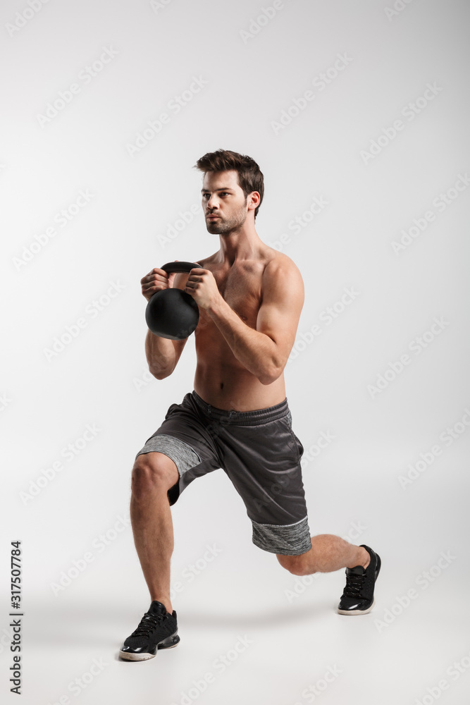 Image of shirtless man doing exercise with weight while working out Image of shirtless man doing exercise with weight while working out