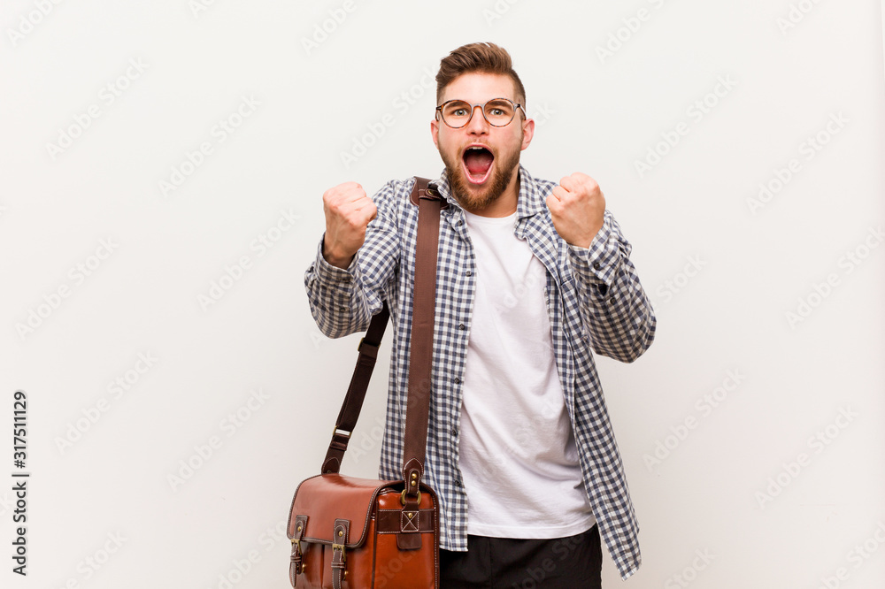Naklejka premium Young modern business man cheering carefree and excited. Victory concept.