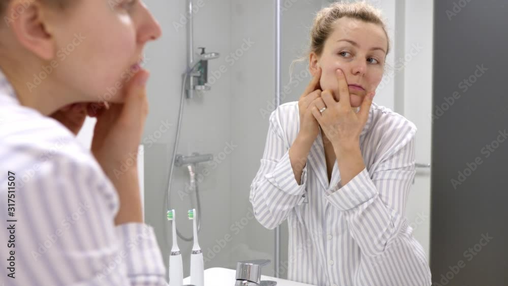 Dissatisfied Woman Finding Acne On Her Face. Skin Problems Concept. Dissatisfied Woman Finding Acne On Her Face. Skin Problems Concept.