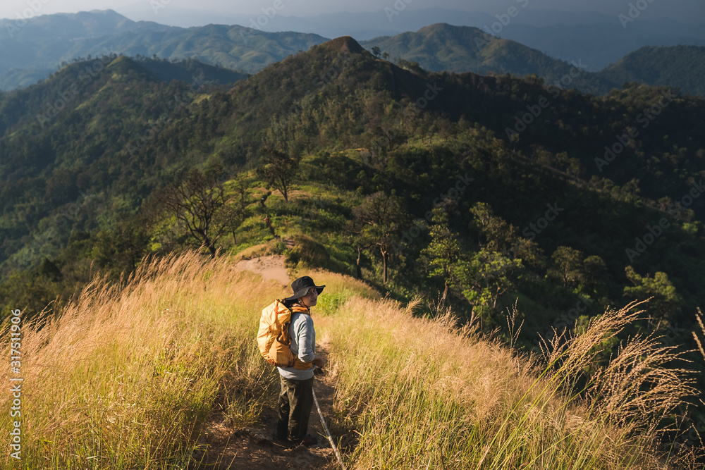 Fototapeta premium Woman hiking over the mountain ridge