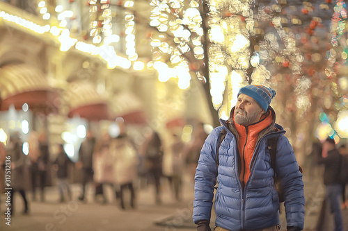 hipster santa in the city night / a young guy with a beard travels around Europe new year and Christmas