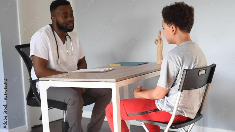 African American doctor with his cute mixed patient. medical checkup. african american teen with a handsome black doctor. African American doctor with his cute mixed patient. medical checkup. african american teen with a handsome black doctor.