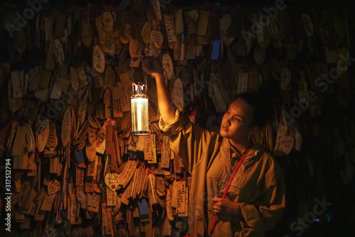 Woman looking at the prayer blocks with lantern