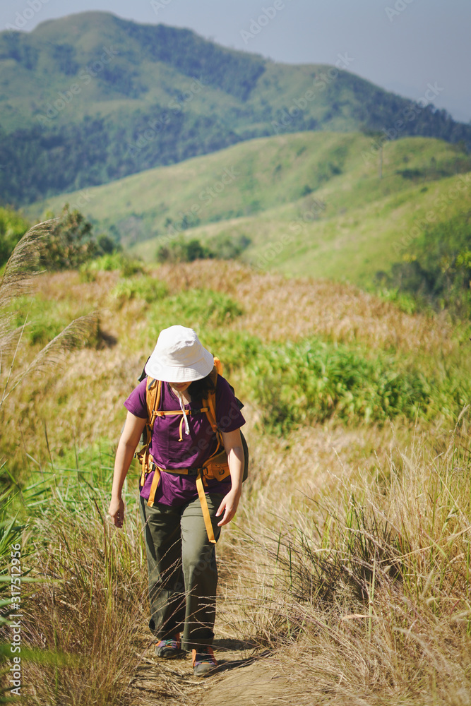 A woman hiker standing on top of mountain A woman hiker standing on top of mountain