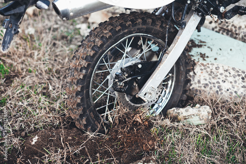 Fototapeta Naklejka Na Ścianę i Meble -  Action the wheel of an Enduro Motorcycle Hits an obstacle in the ground