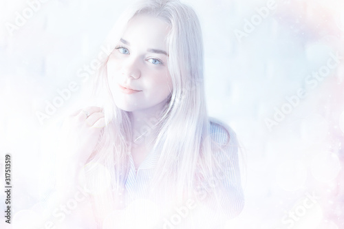 Fototapeta Naklejka Na Ścianę i Meble -  cute blond young adult / portrait of an adult beautiful girl model with blond hair in a happy image