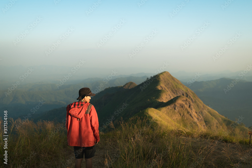 A male hiker with his backpack hiking over the mountain