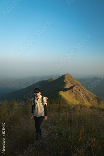 A male hiker with his backpack hiking over the mountain