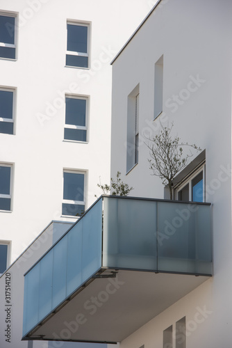 Modern concrete balcony s in a cut out on blue sky