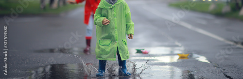 Foto child in a raincoat autumn / autumn view a small child in a raincoat, a park in
