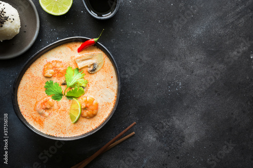 Tom yam kung spicy thai soup with shrimp, seafood, coconut milk, chili pepper and rice.