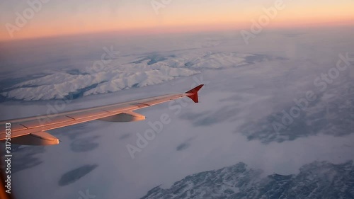 View of the Khibiny mountain above the Arctic circle in Russia's Kola peninsula from a plane flying to Murmansk at dawn in winter. The only mountains in the area, they emerge from the white plains