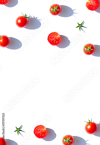 Organic cherry tomatoes on the white background. Top view food frame. Copy space