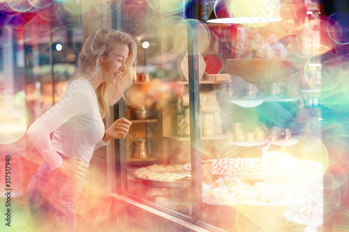 girl in a pastry shop, delicious sweet food, a young adult woman stands at the window