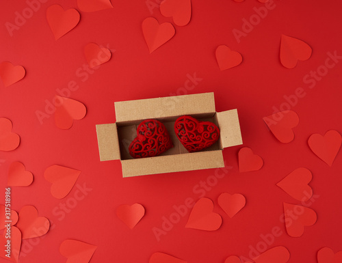 hearts cut out of red paper on a red background