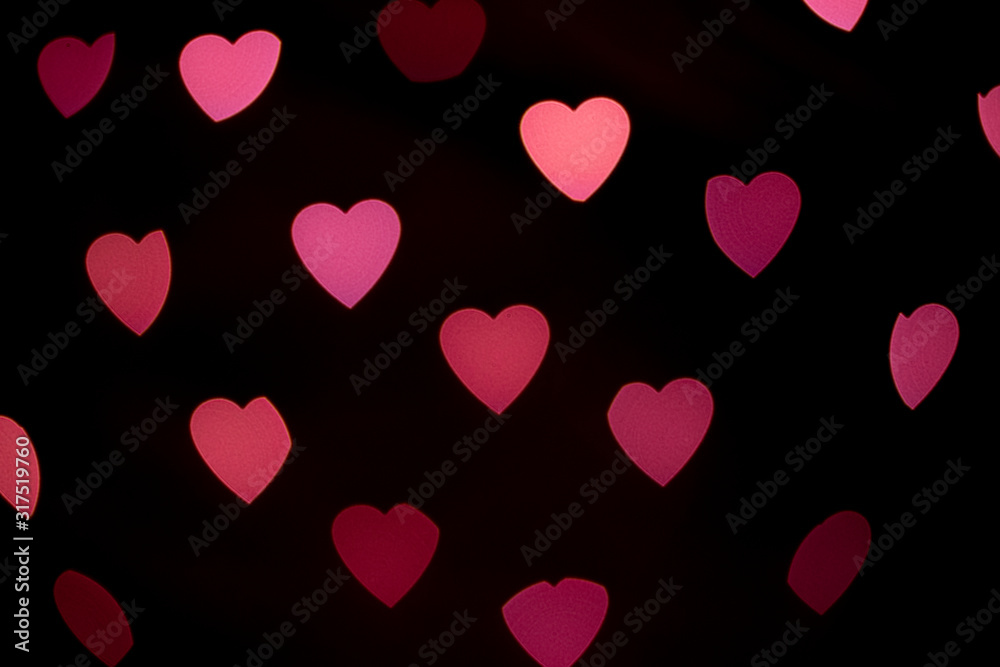 Valentines background. Abstract heart bokeh background. Defocused blurred heart shaped lights. Valentines Day background