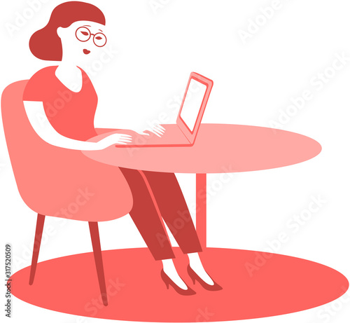 young woman sitting at his desk using laptop