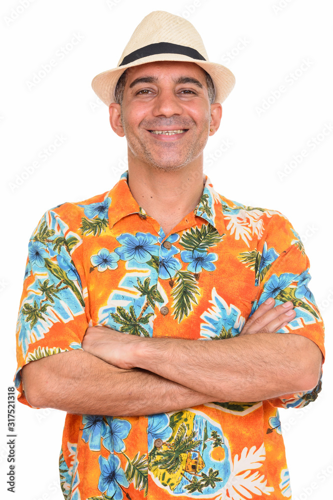 Portrait of happy mature Persian tourist man smiling with arms crossed Portrait of happy mature Persian tourist man smiling with arms crossed