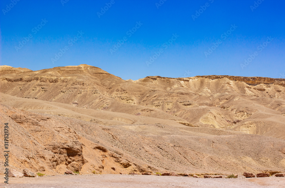 desert landscape sand stone ground hills wasteland scenic dry environment view horizon hill land range background