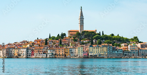 view from water, on Church of St Euphemia and colorful houses of Rovinj, Croatia panorama
