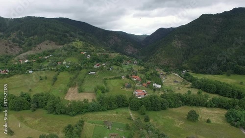 Picturesque aerial landscape with of Serbian uplands. Small village on green mountain slope. Part 1 photo