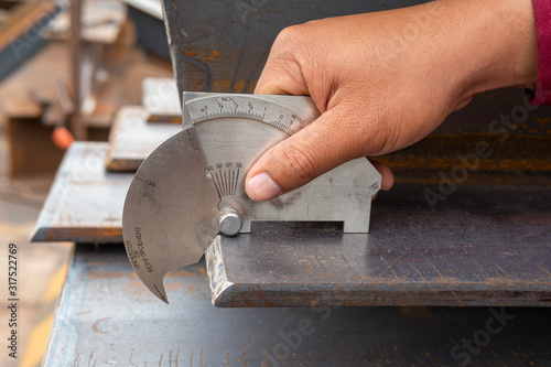 Using the welding gauge to measure the angle of edge h-beam after cutting.
