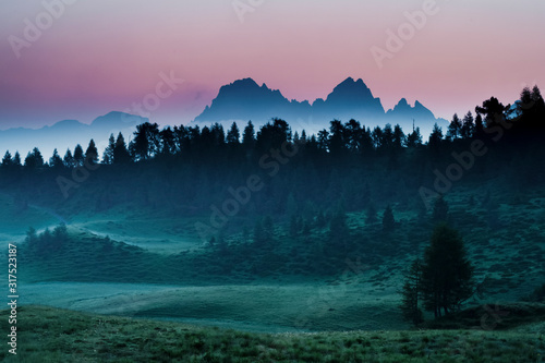 The dawn paints the sky above the Creton of Clap Grande mount in Carnia, Sauris, Friuli Venezia Giulia, Italy, Europe photo