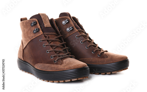 Pair of brown male boots isolated over white background