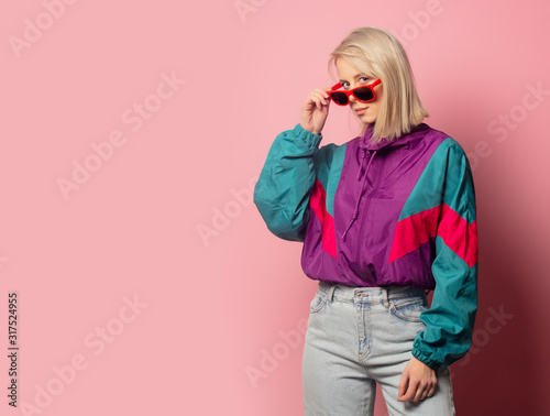 Beautiful blonde woman in sunglasses and 90s clothes