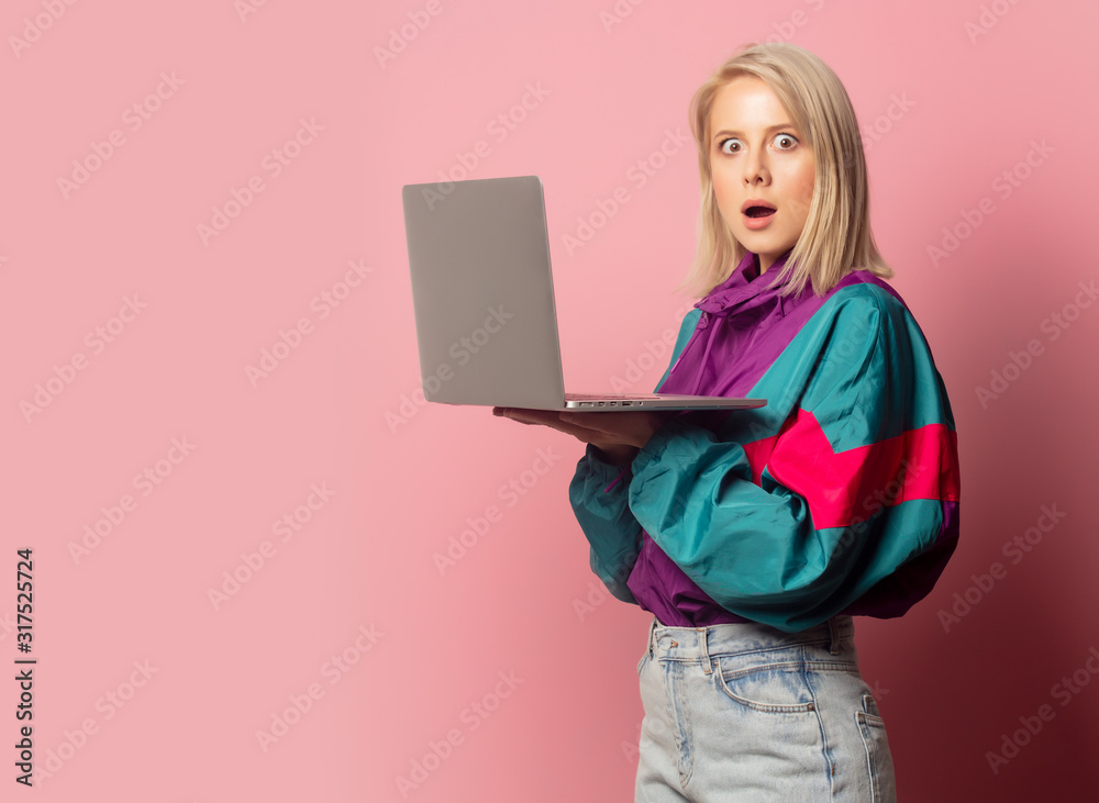 Beautiful blonde woman in 90s clothes with laptop computer Beautiful blonde woman in 90s clothes with laptop computer