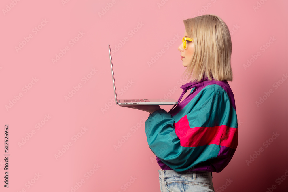 Beautiful blonde woman in 90s clothes with laptop computer Beautiful blonde woman in 90s clothes with laptop computer