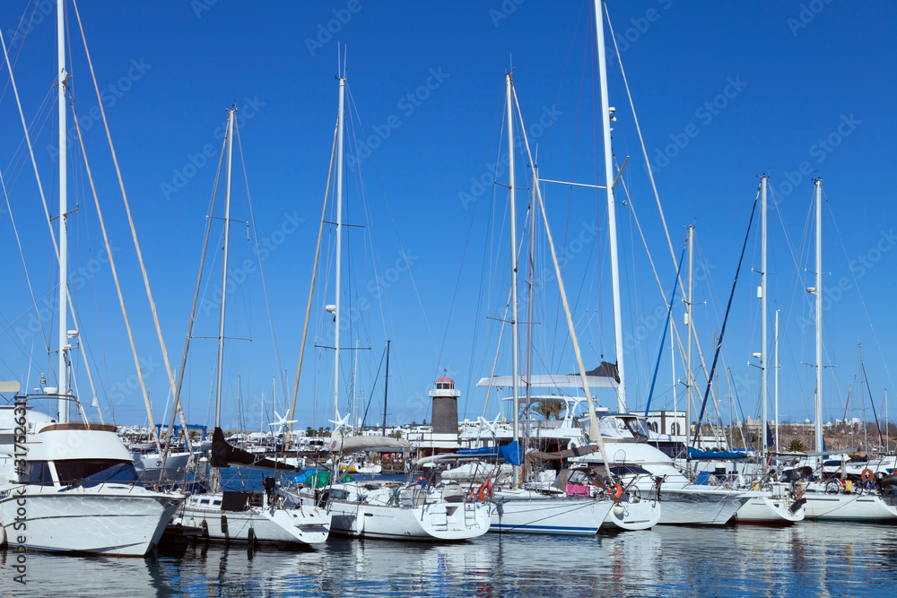 Variety of yachts, sail and motor boats mooring in a harbor ,