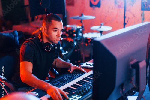 Sound engineer working and mixing music indoors in the studio