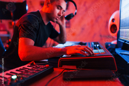 Professional sound engineer working and mixing music indoors in the studio photo