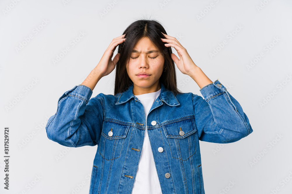 Young asian woman touching temples and having headache. Young asian woman touching temples and having headache.