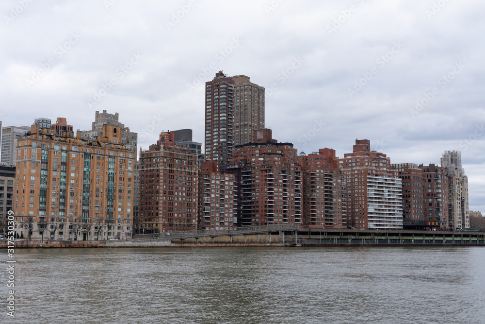 Upper East Side Manhattan Skyline in New York City along the East River on a Cloudy Day	