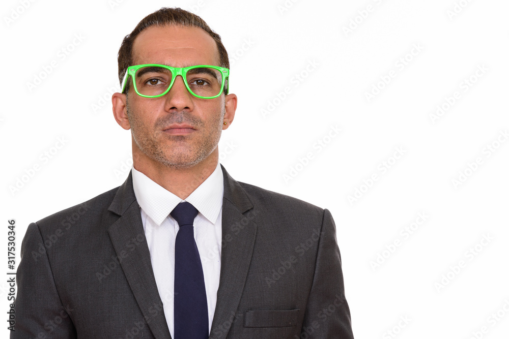 Face of mature handsome Persian businessman with eyeglasses