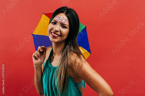 Young woman celebrating the Brazilian carnival party with Frevo umbrella photo