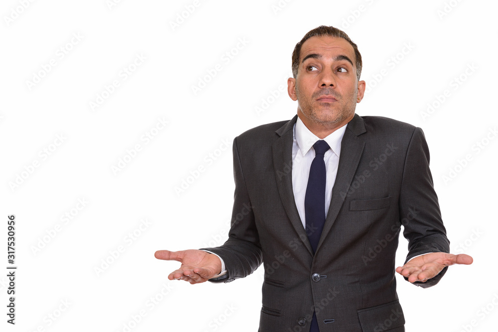 Portrait of mature Persian businessman shrugging shoulders Portrait of mature Persian businessman shrugging shoulders