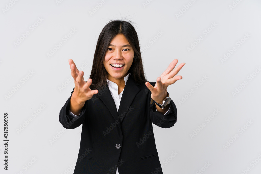 Young asian business woman feels confident giving a hug to the camera. Young asian business woman feels confident giving a hug to the camera.