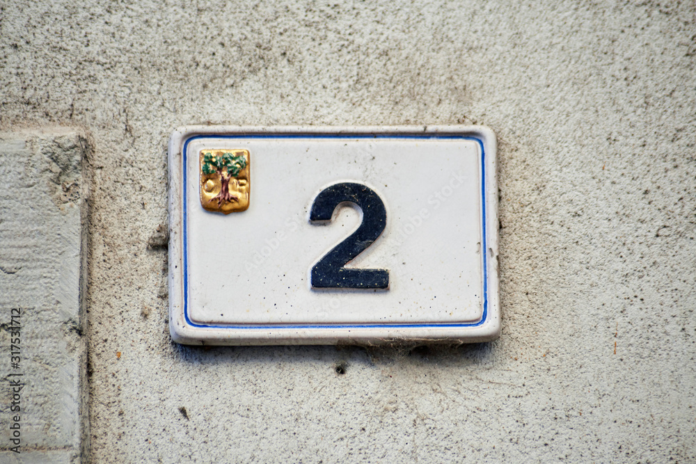 Italian house number ceramic plate sign mounted on the wall. With number 2 (two). Italian house number ceramic plate sign mounted on the wall. With number 2 (two).